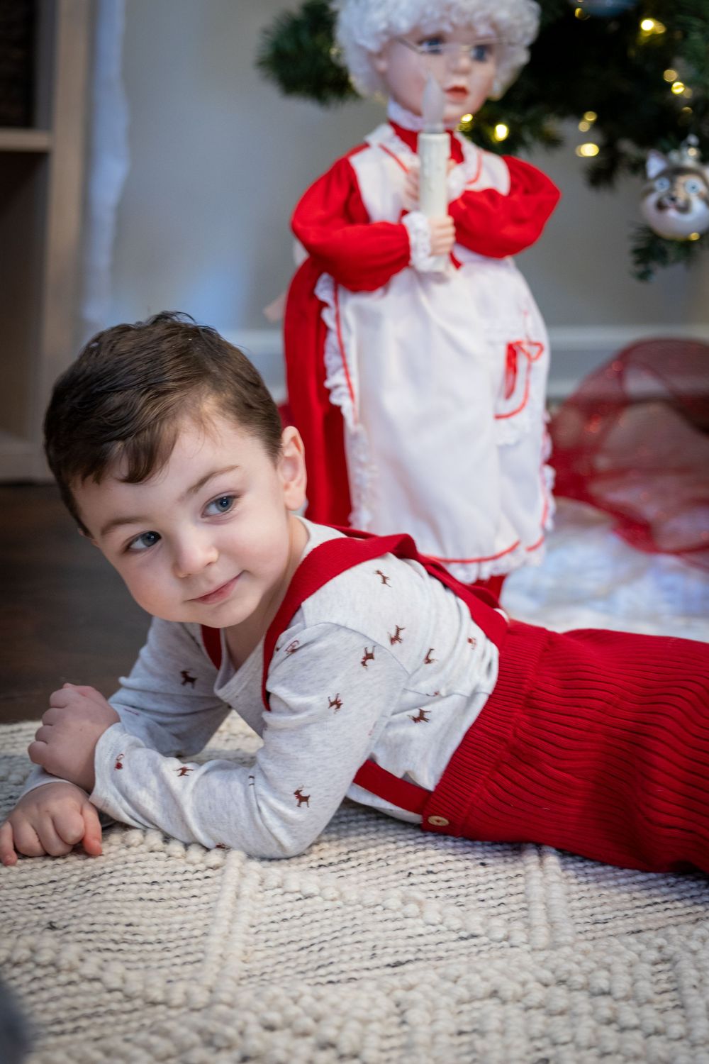 Holiday themed indoor portrait session with festive red and white decor.