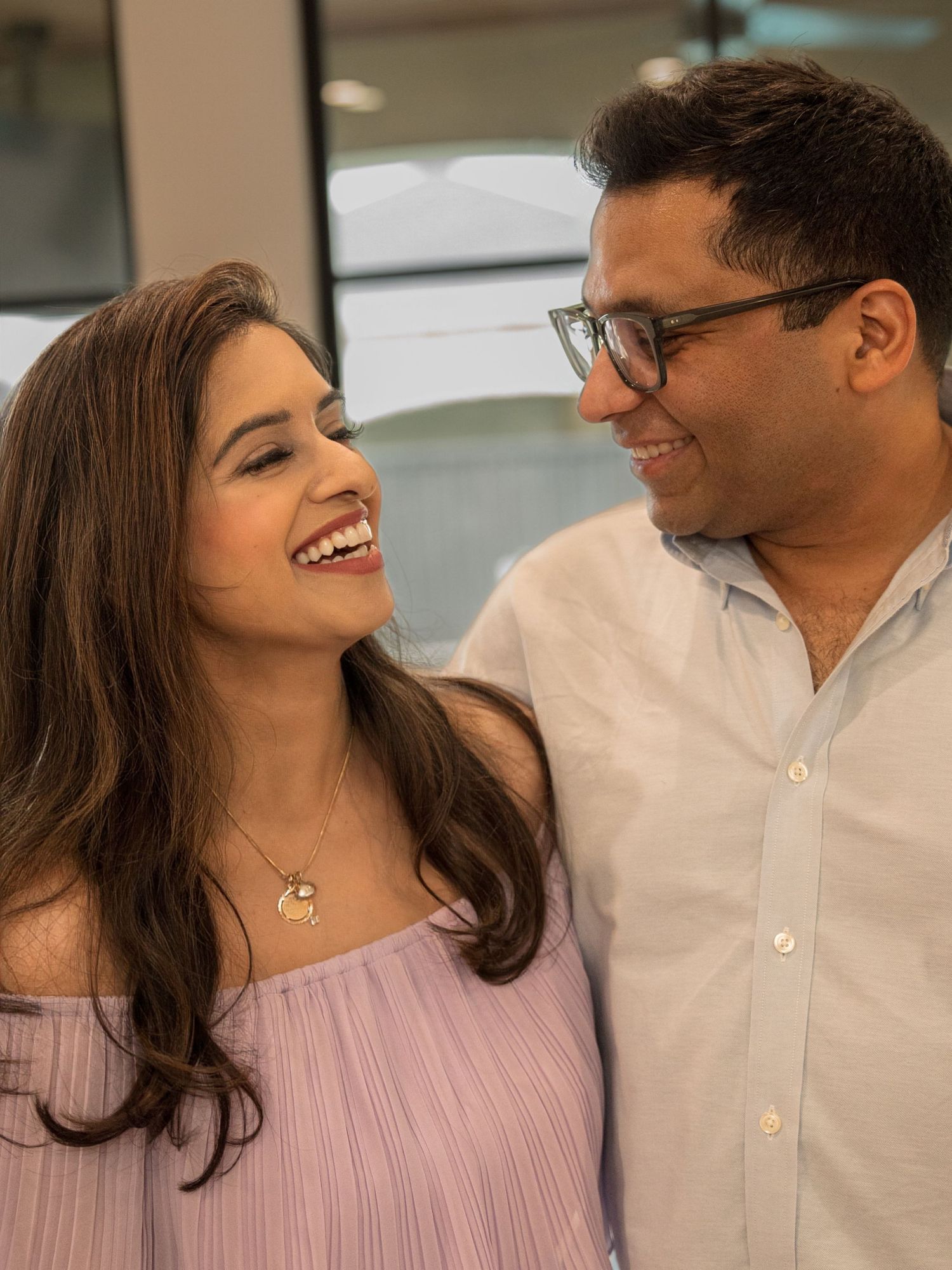 A couple shares joyful laughter together in a series of candid outdoor photos showing genuine connection and happiness.