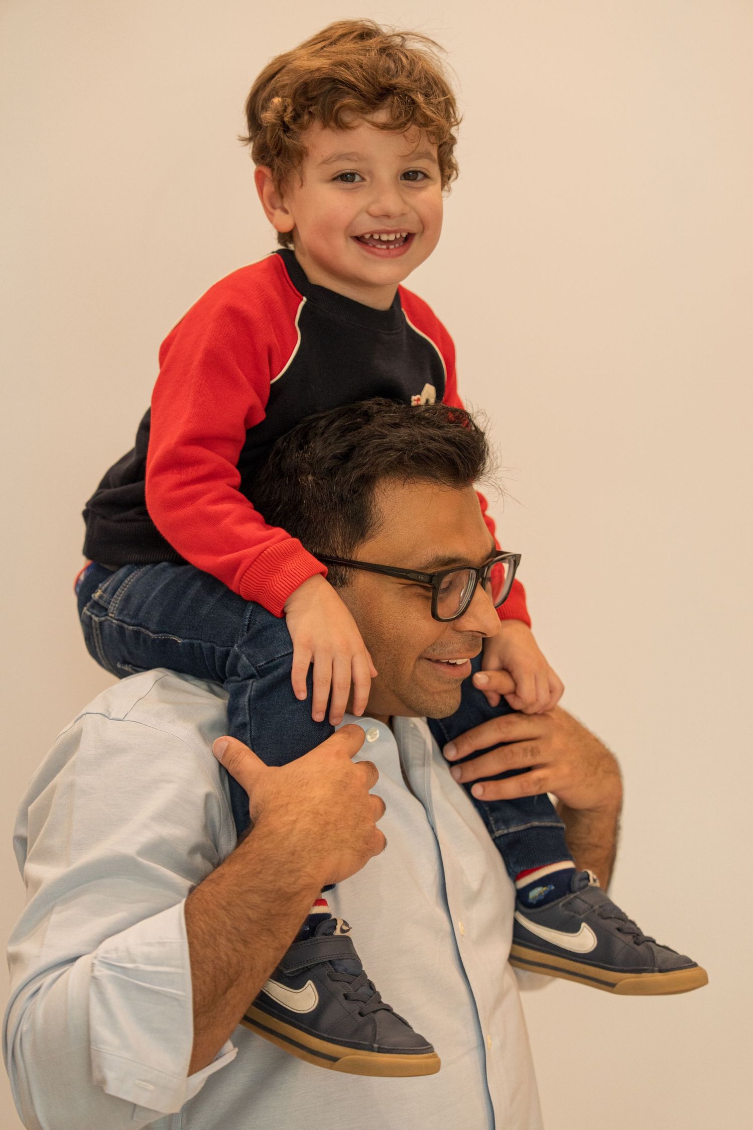 A playful sequence shows a child sitting on someone's shoulders while both share joyful expressions.