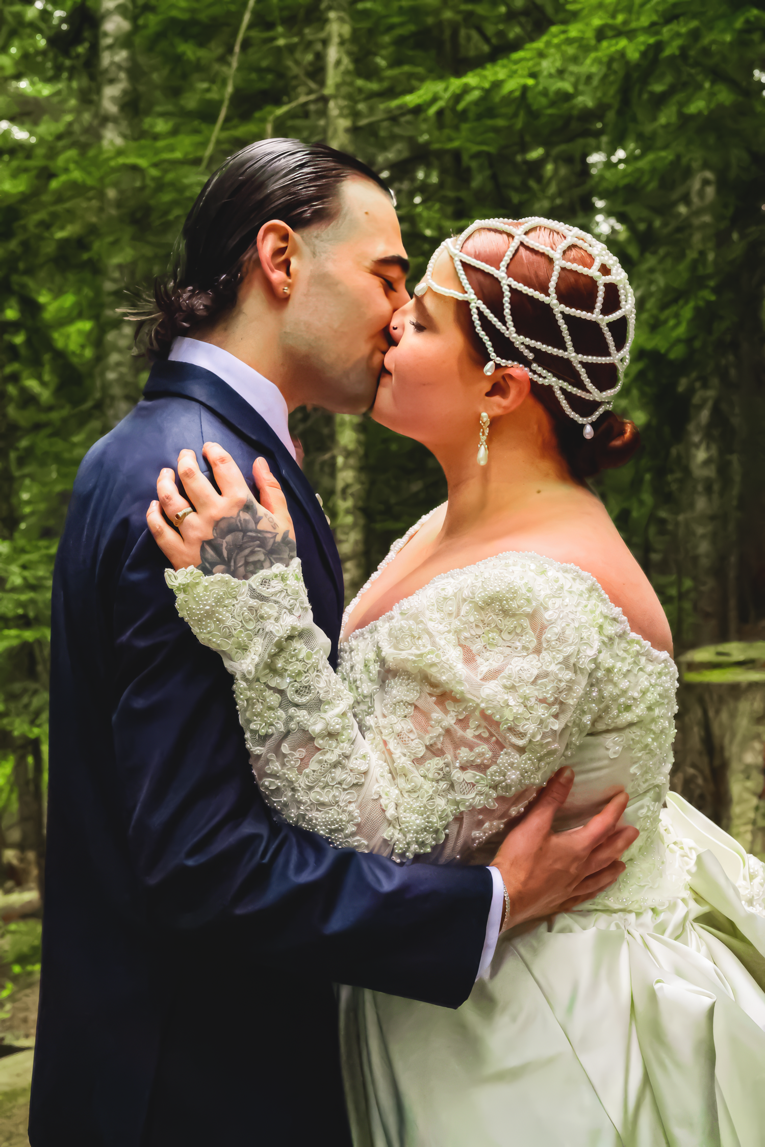 A romantic outdoor wedding scene features a couple kissing in a lush forest setting.