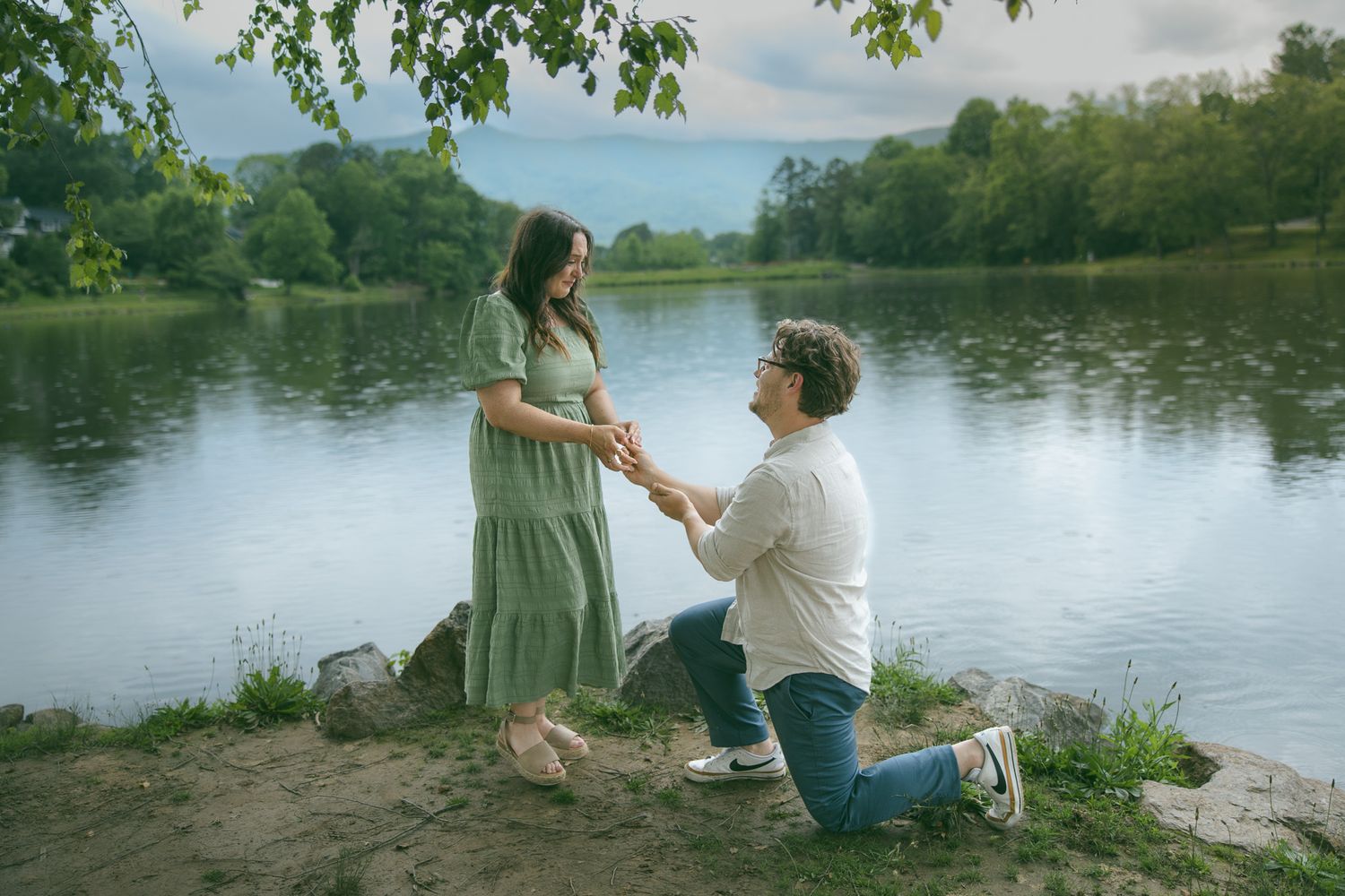 engaged couple during proposal at a romantic blue ridge mountain overlook near Asheville, North Carolina