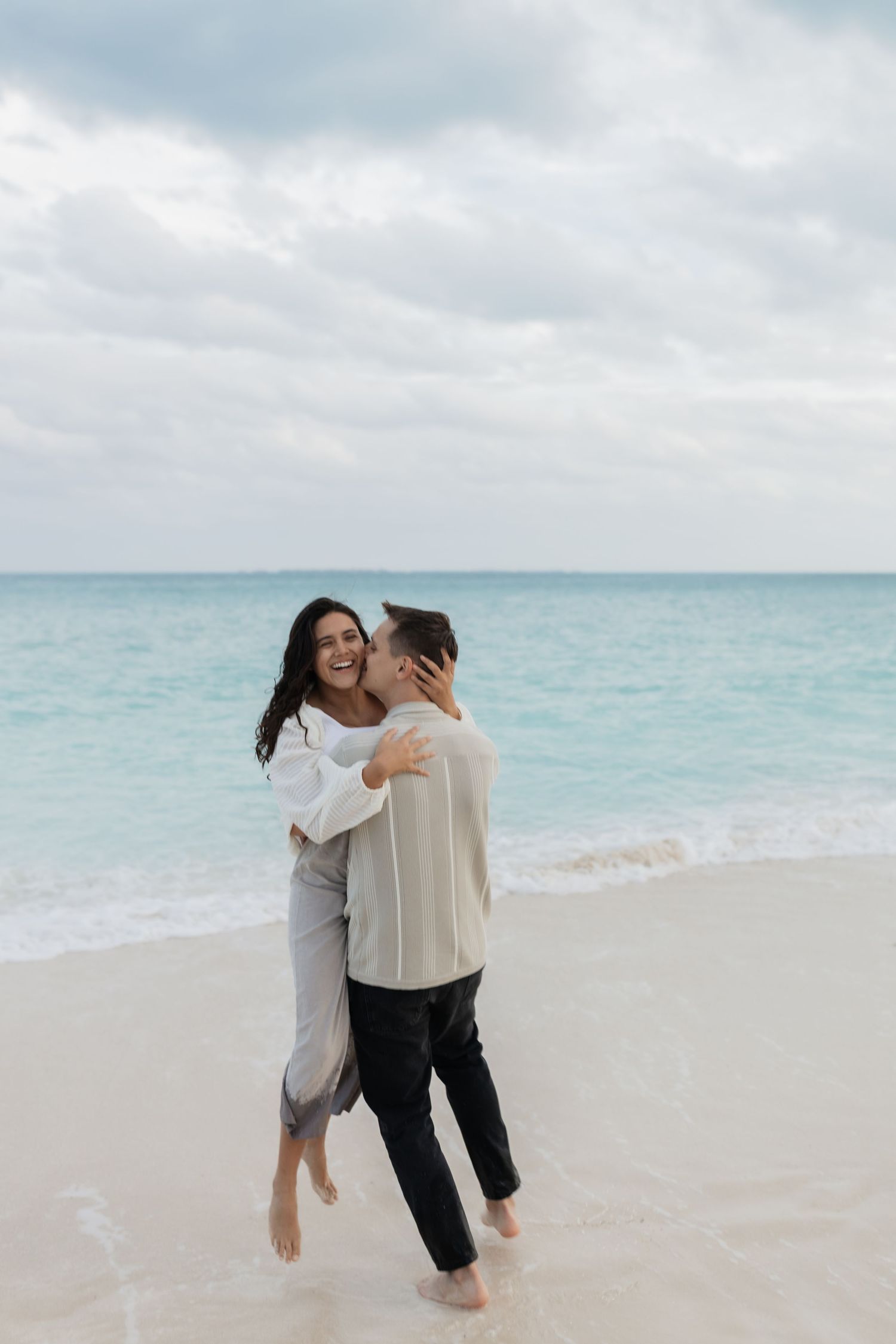 Fun beach portrait of Marco and Fernanda from FilmMar MX, natural wedding photographer and videographer team in Riviera Maya.