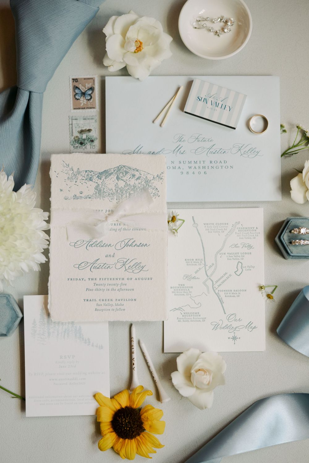 Elegant wedding invitation suite with floral details, sunflower accents and delicate calligraphy.