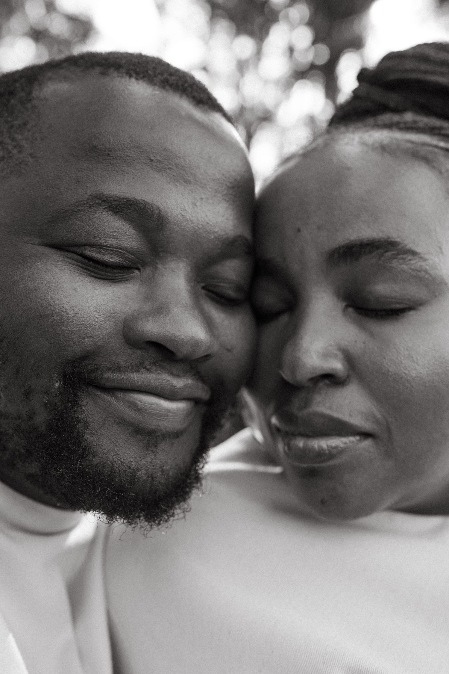 Close-up black and white portraits showing tender moments between a couple.