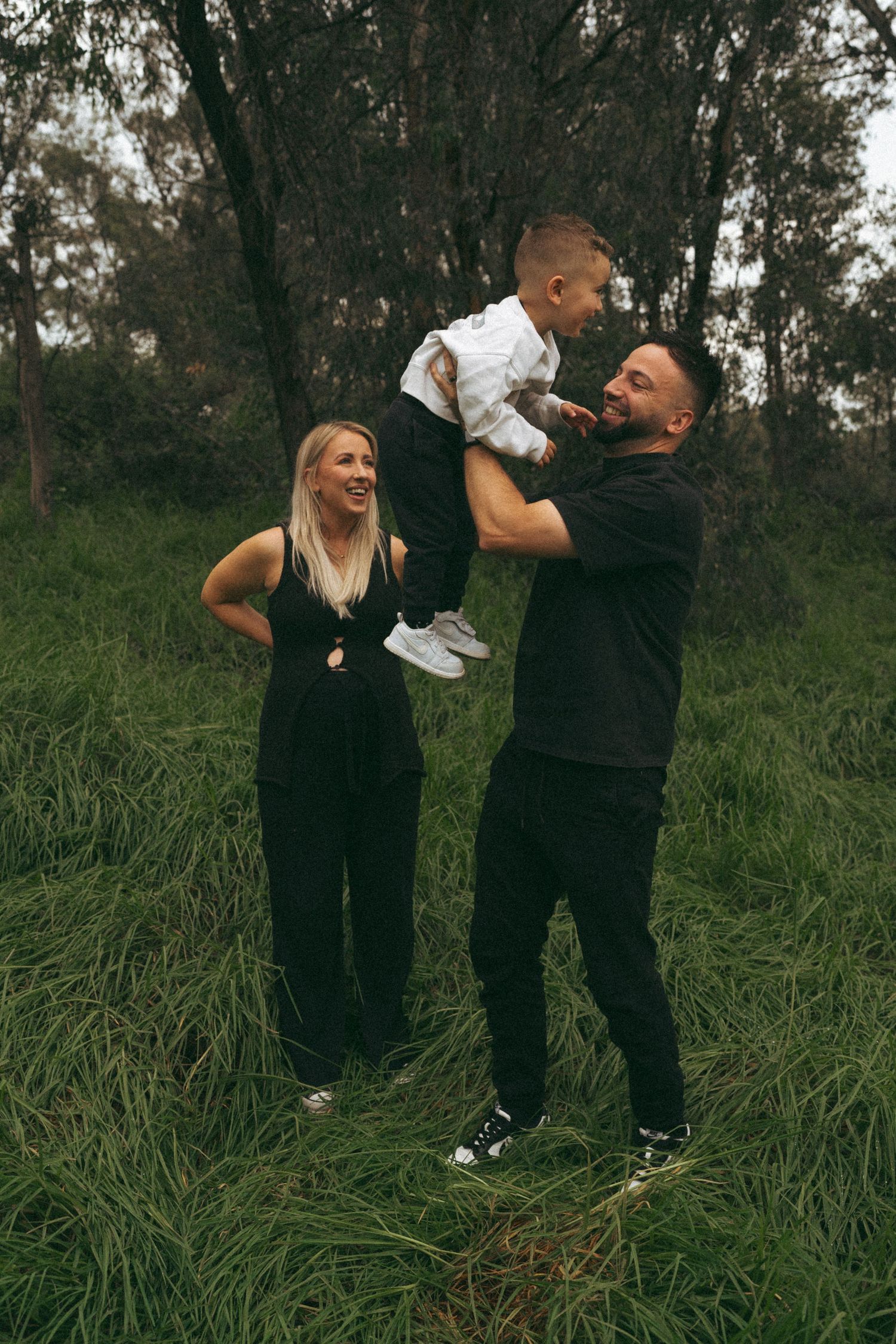 Candid family moments captured in a grassy field setting.