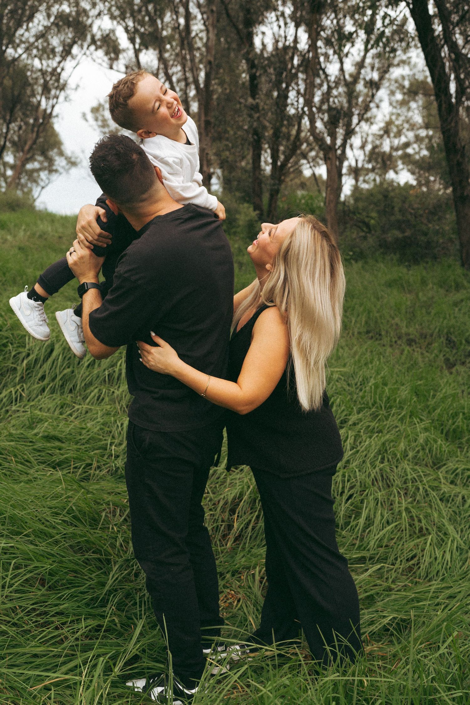 A series of candid shots showing a couple's playful interaction in tall grass.