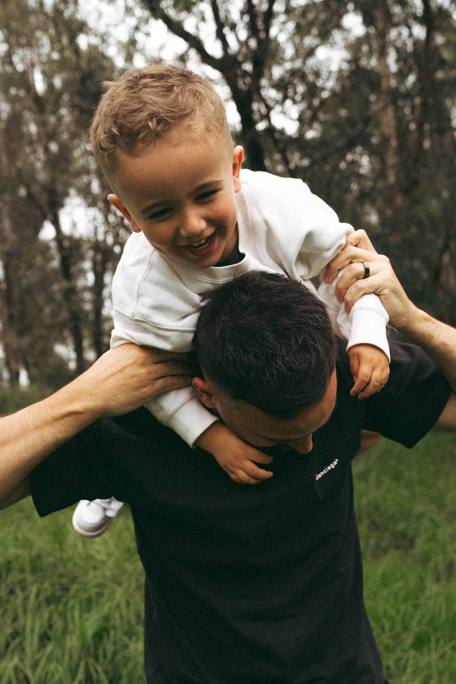 Playful outdoor moments captured between adult and child in natural setting.