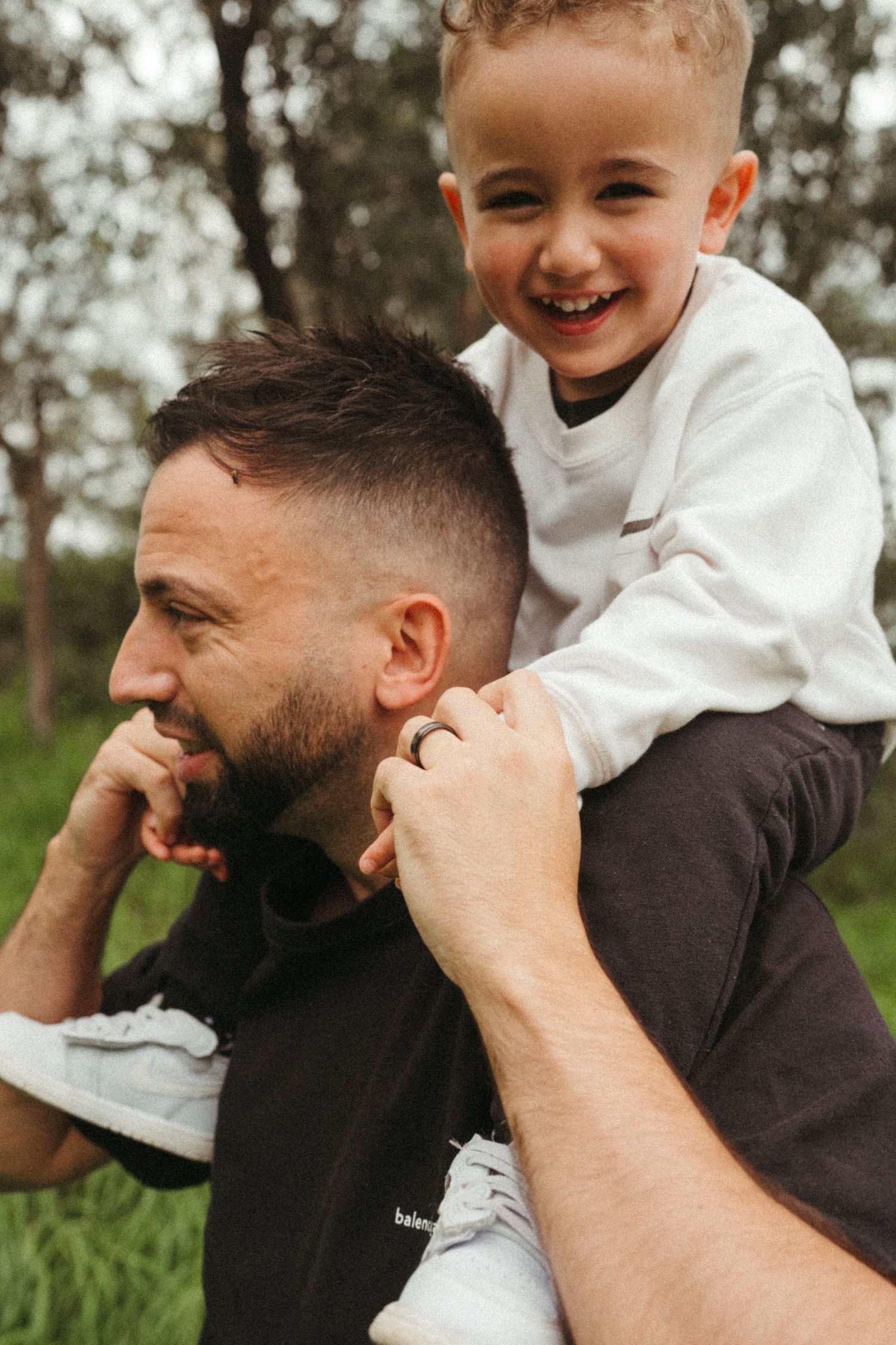 Candid moments of laughter between adult and child in natural setting.