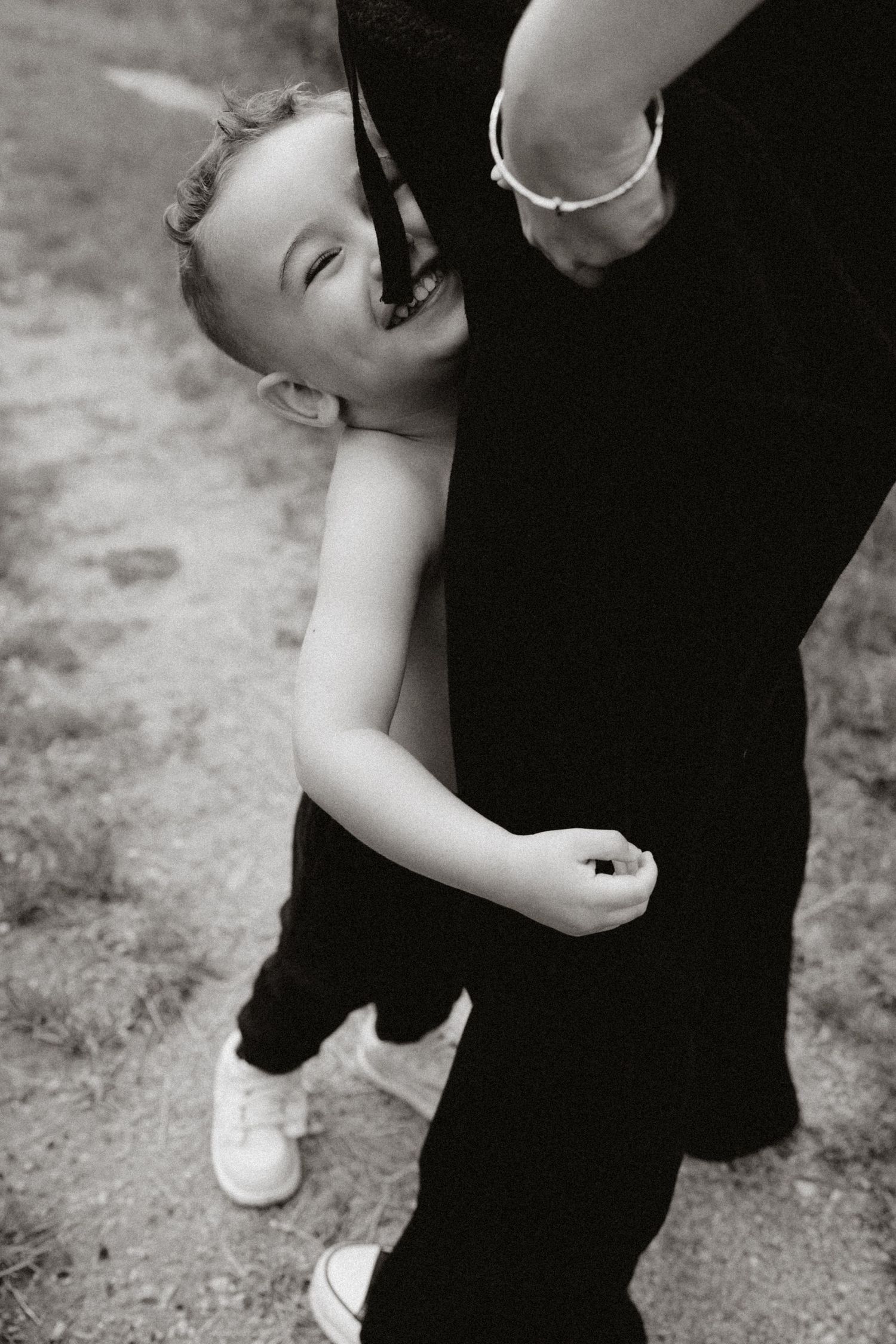 Black and white candid photo capturing laughter and joy between two people.