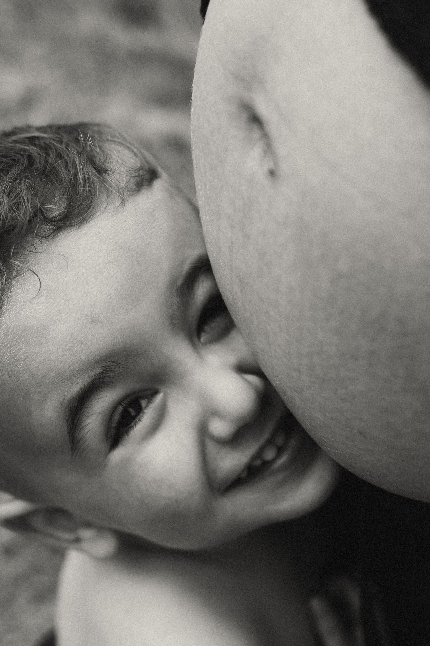 Black and white intimate series capturing gentle bonding moments between parent and child.
