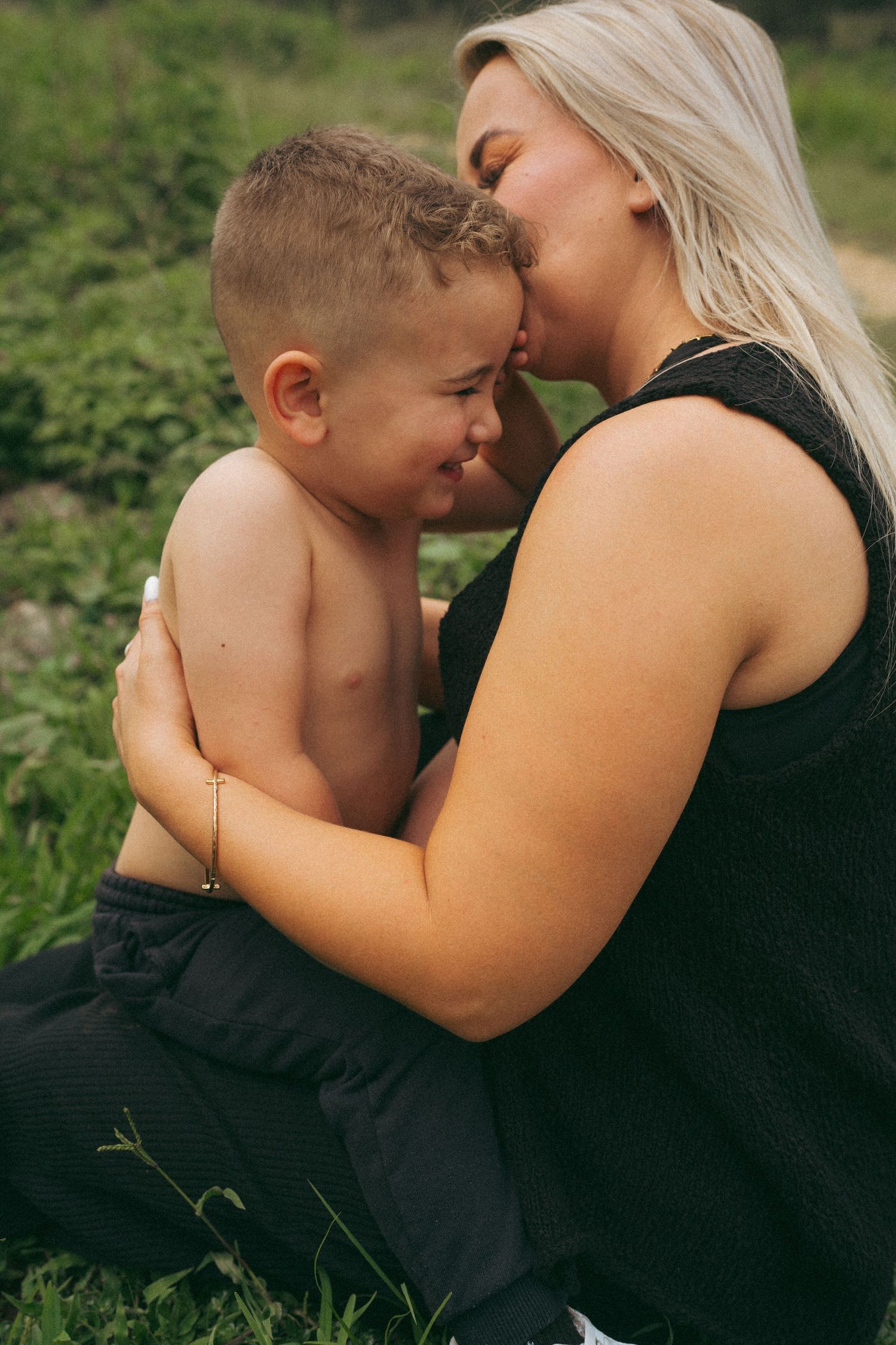 Emotional outdoor portrait series showing tender moments between parent and child.
