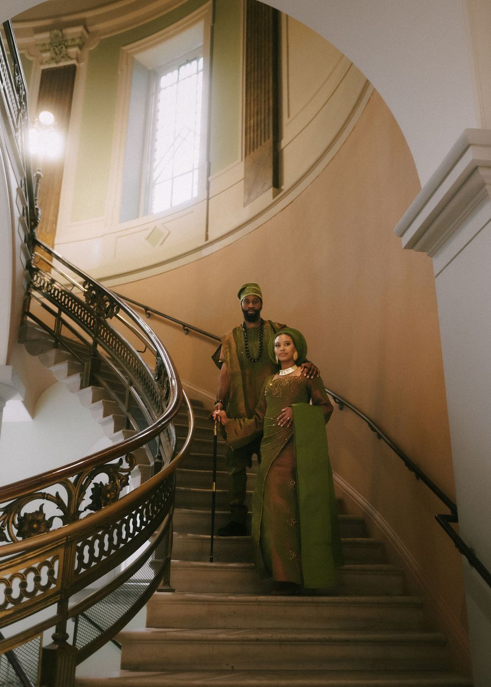 Series of photos on a grand curved staircase in a historic building interior.