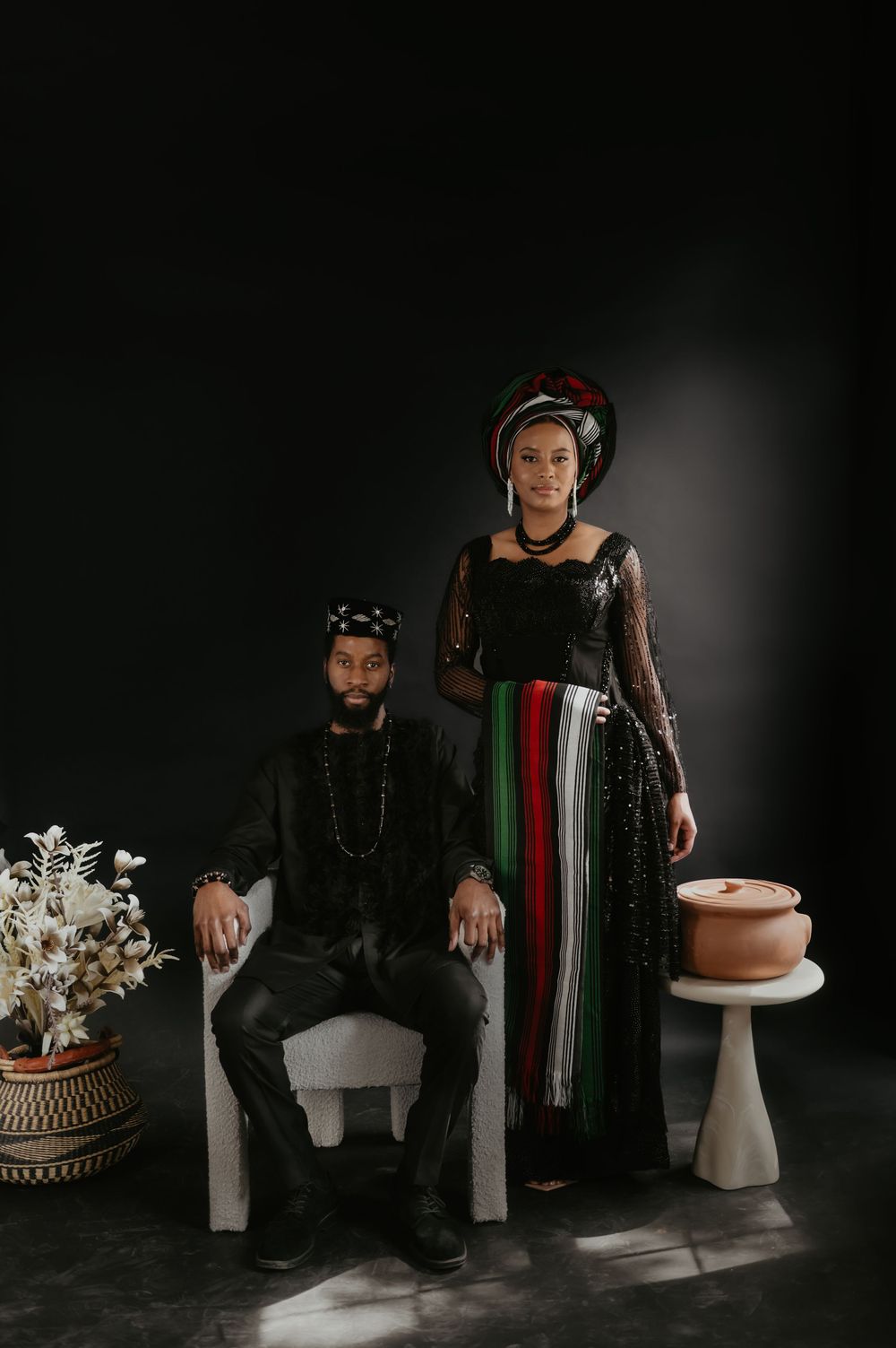 Artistic photo series featuring traditional African attire and white pedestals against a dark backdrop.