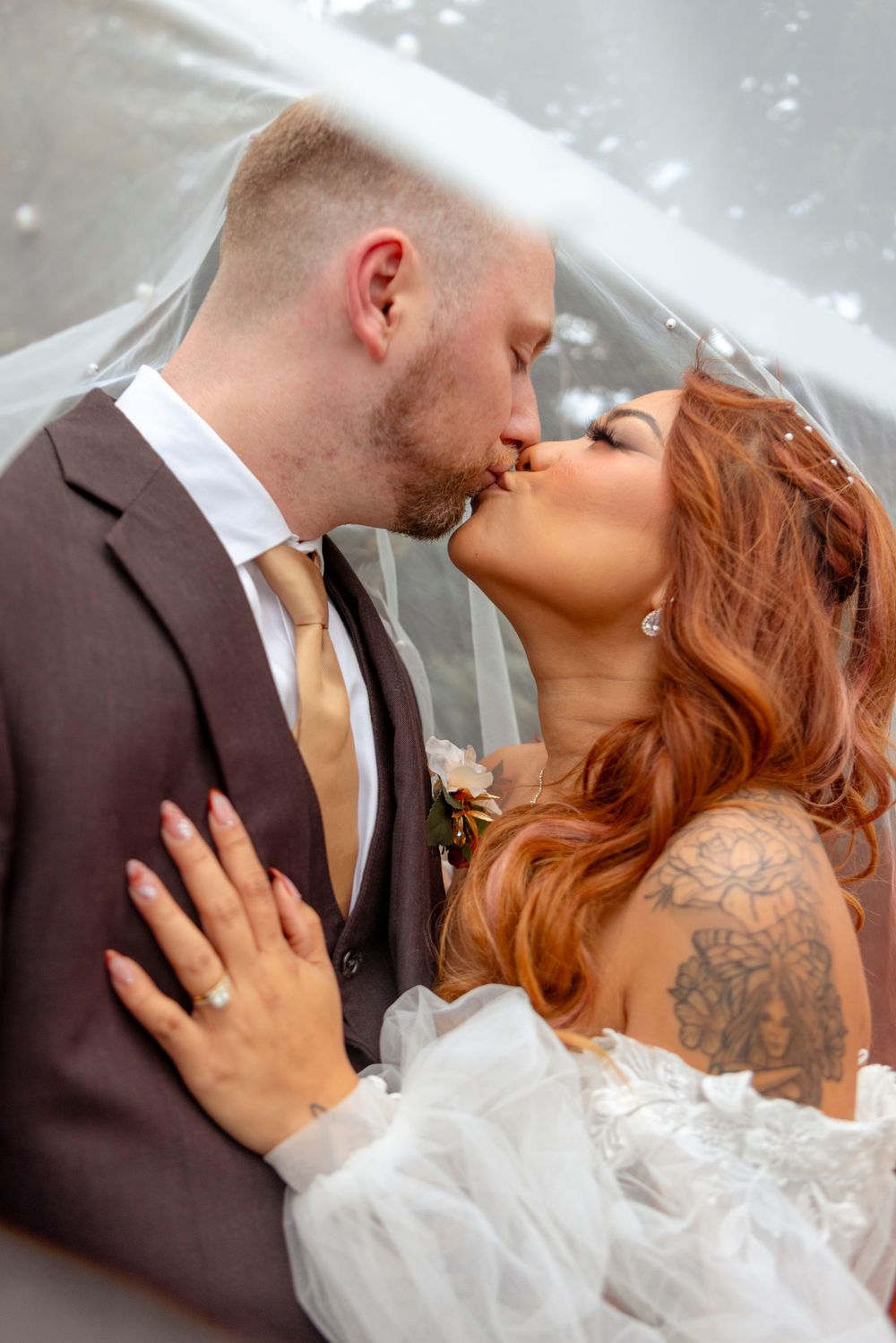 Romantic wedding photo sequence showing intimate moments between newlyweds under a white veil.