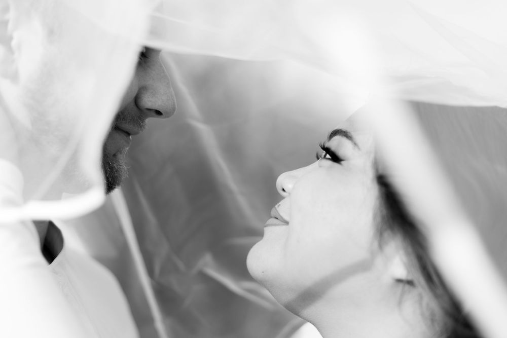 Black and white artistic portrait photograph showing a side profile silhouette against a light background.