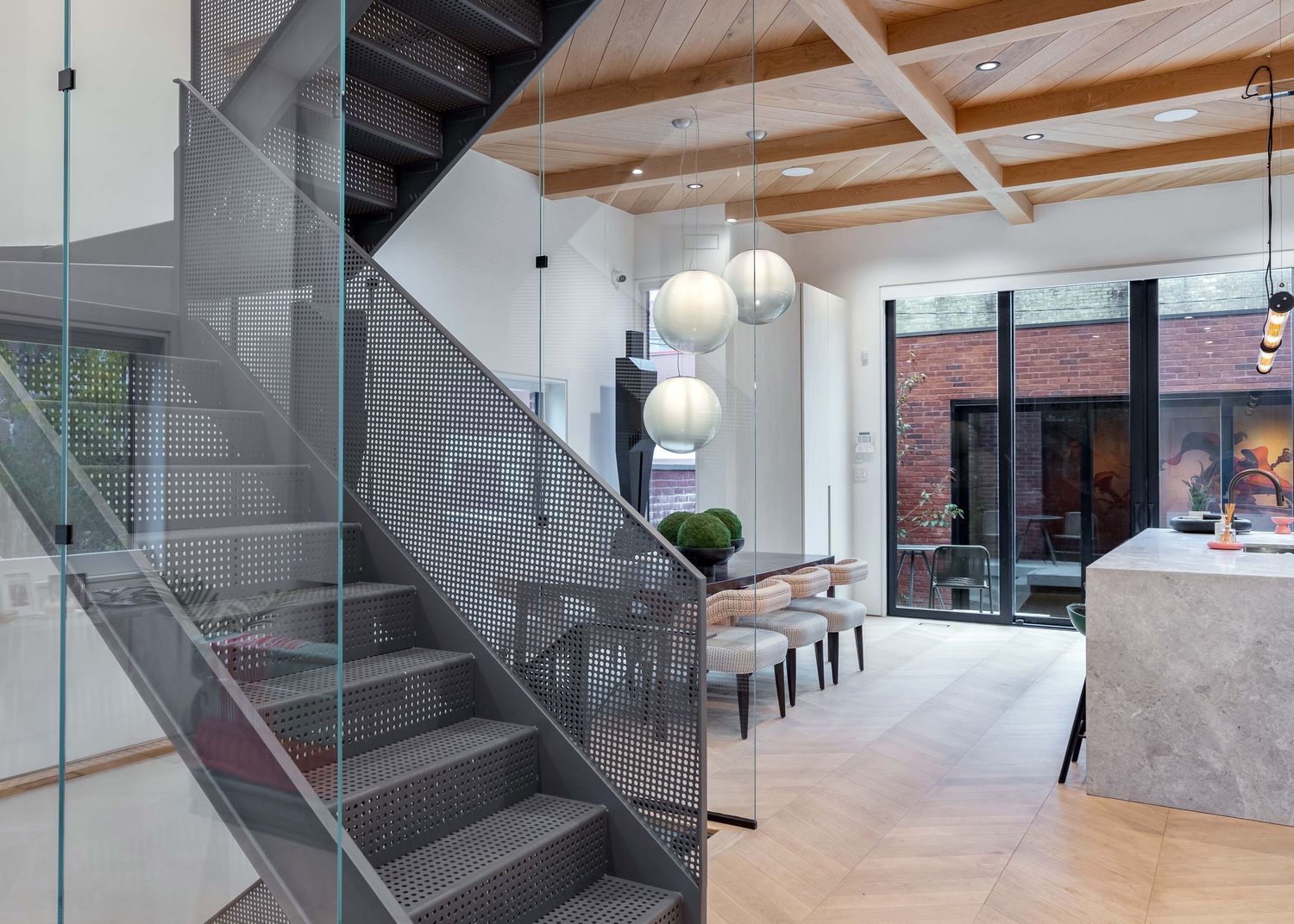 Modern interior staircase with glass railings and wooden accents in a contemporary office or residential space at 5 Whitaker Ave, Toronto.