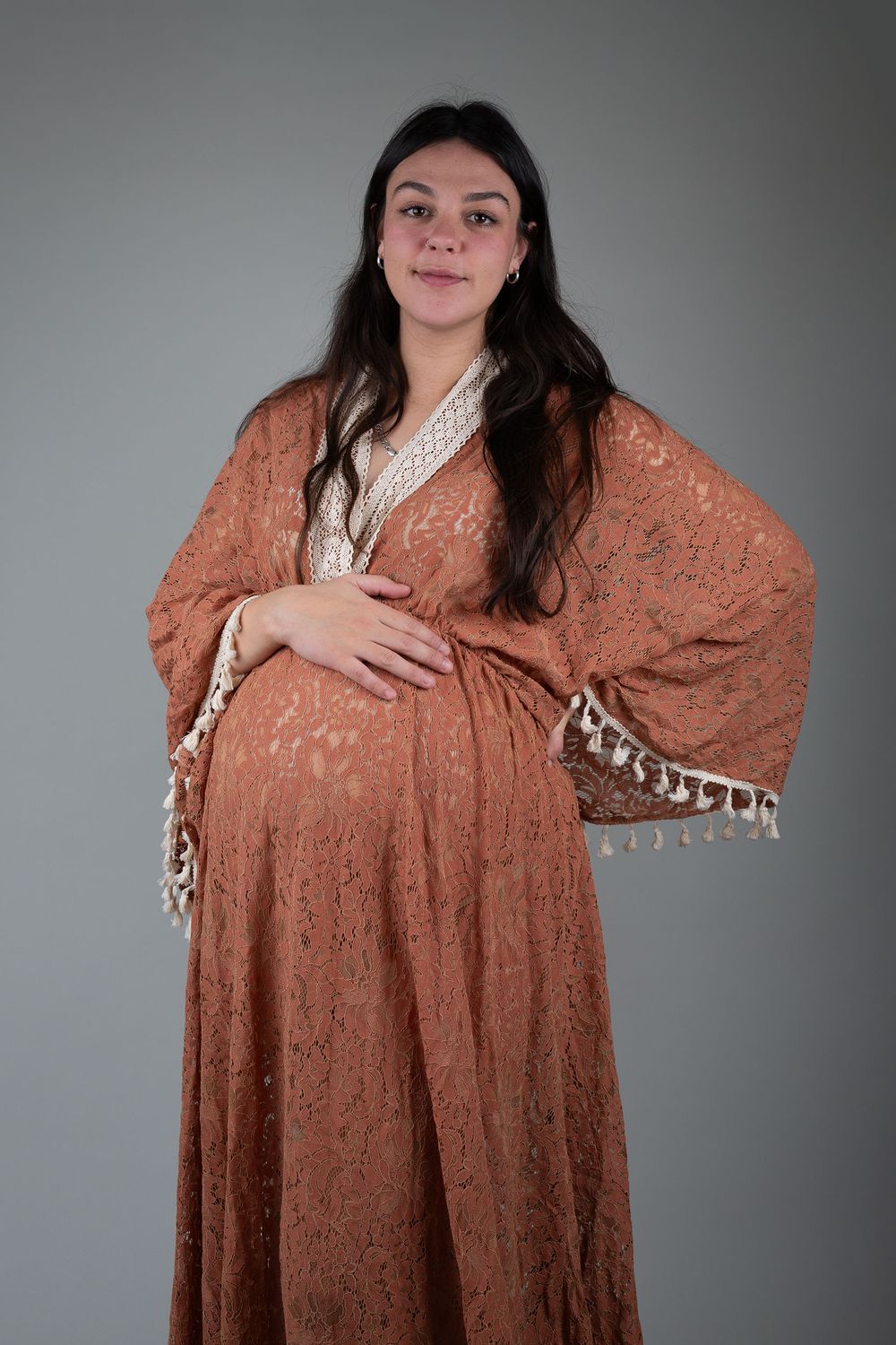 Pregnant mother wearing a rust, boho gown during a photoshoot with Ceris Hicks Photography