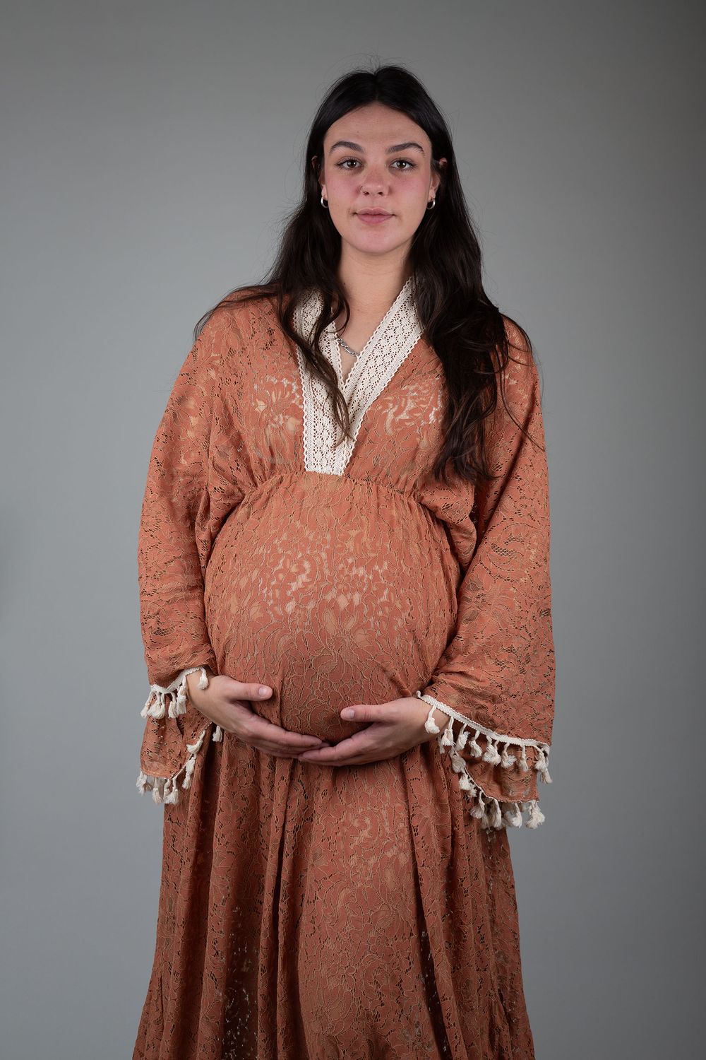 Mother-to-be holding her baby bump during maternity photoshoot with Ceris Hicks Photography