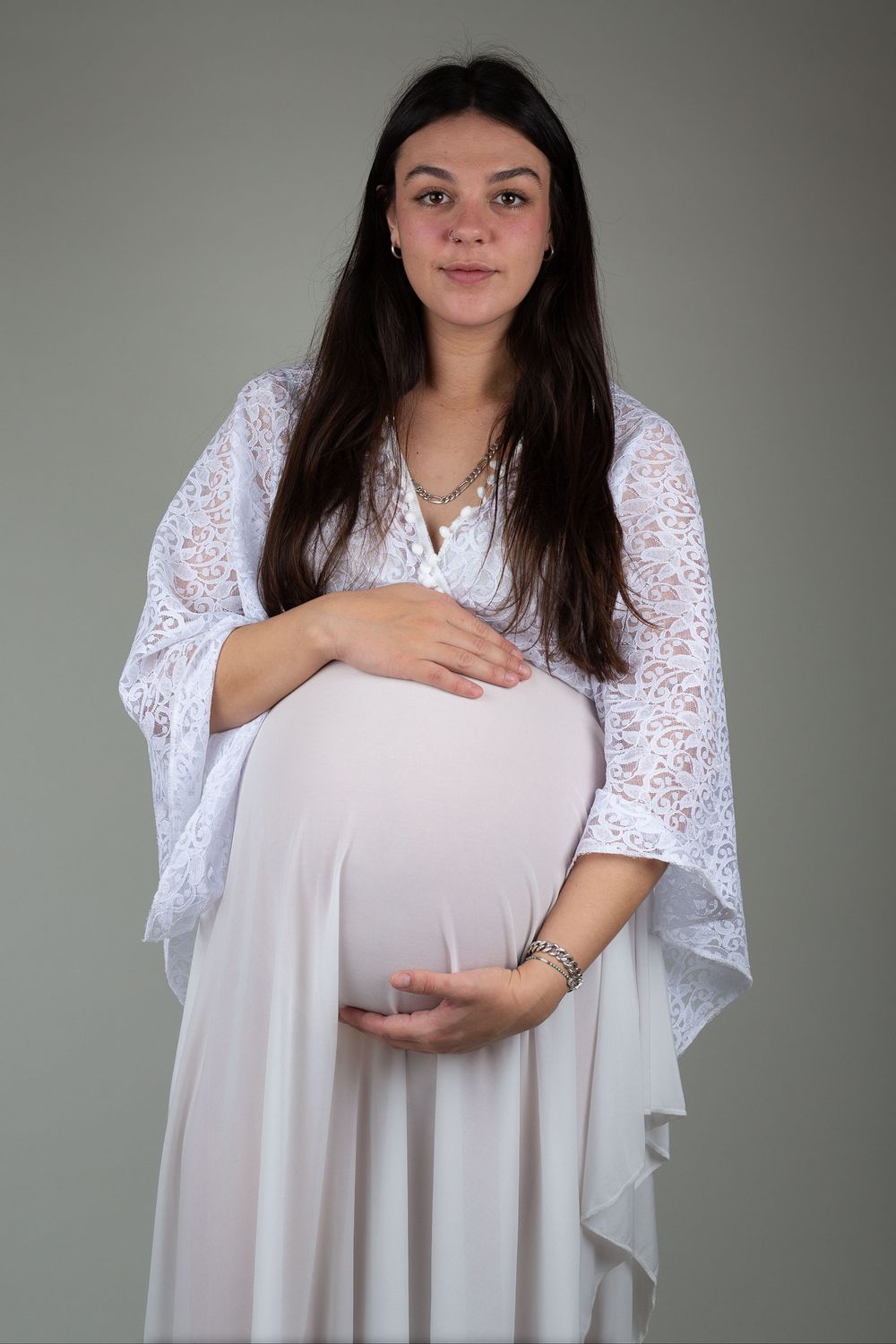 Pregnant mother wearing a beautiful, white, boho maternity gown during a session with a Ceredigion maternity photographer