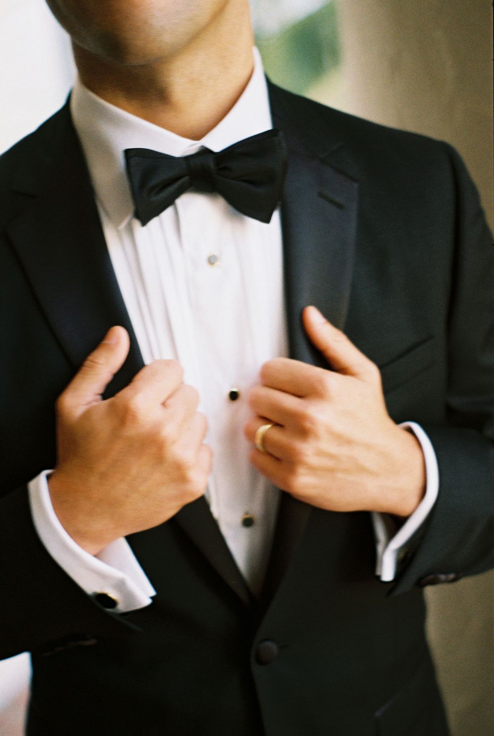 A groom shows off his tuxedo at the Santa Barbara County Courthouse for a micro wedding