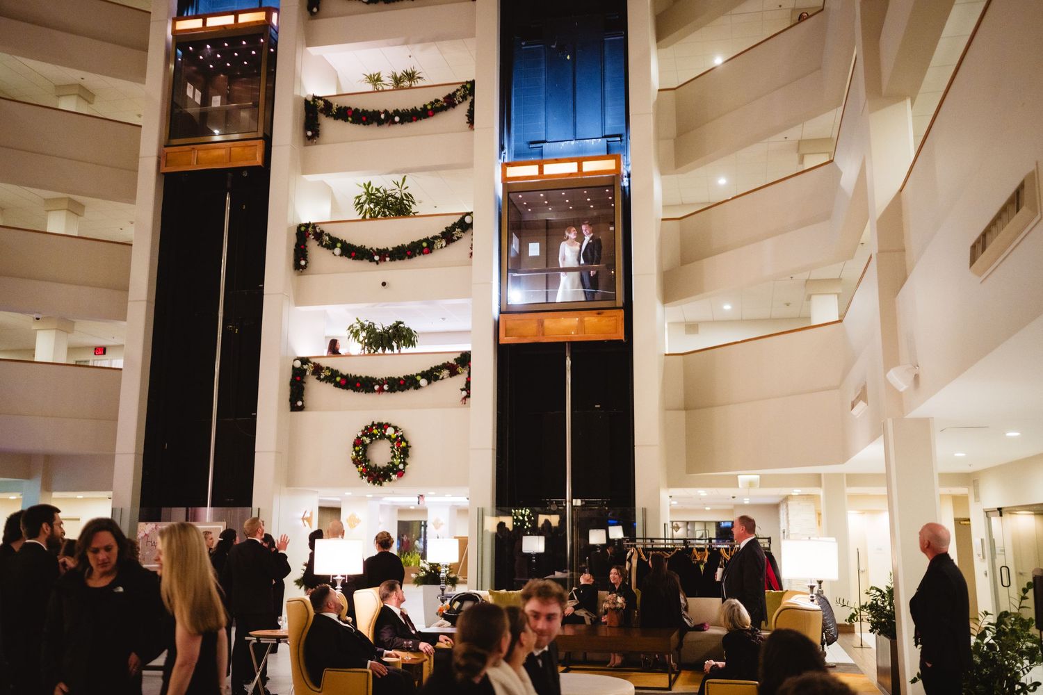 Interior view of a white church sanctuary decorated for Christmas with wreaths and garlands.