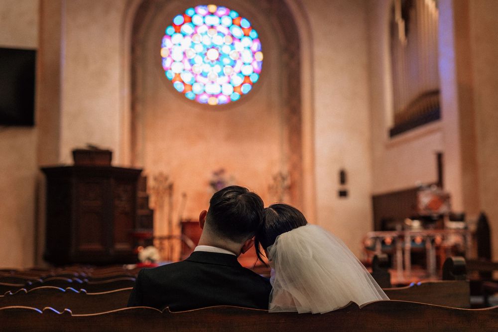 Santa Barbara wedding photographer capturing the rich, jewel-toned colors of the historic stained glass windows inside the Unitarian Society
