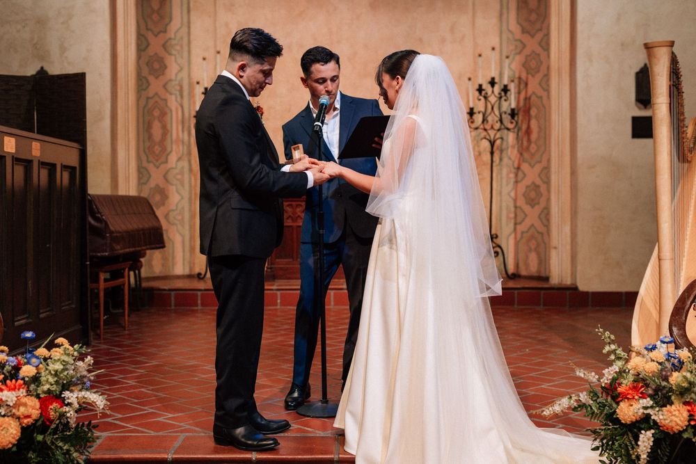 An intimate ring exchange photographed by Santa Barbara wedding photographer at the Unitarian Society of Santa Barbara.