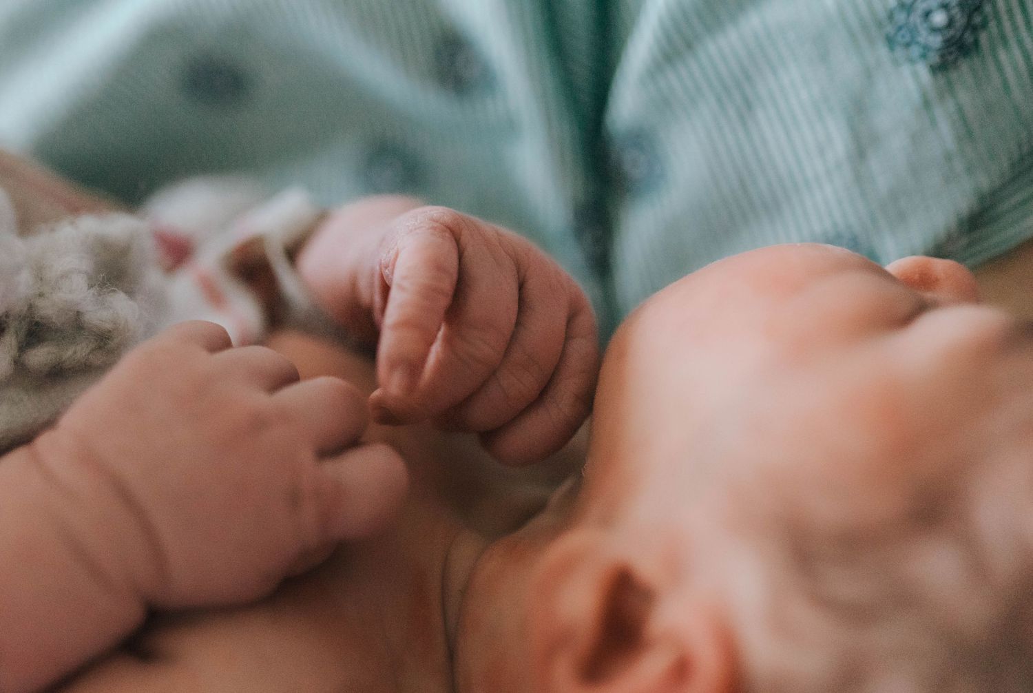 Close up shot of newborn fingers during fresh 48 birth session.