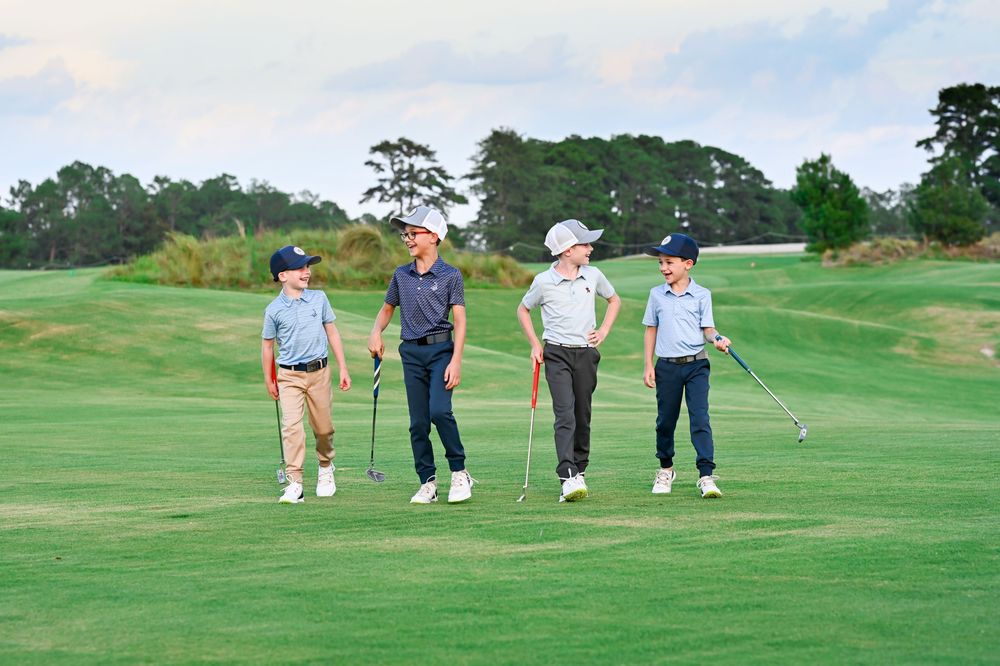 Group of golfers standing together on lush green golf course.