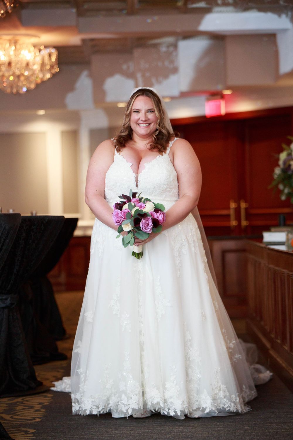 White lace wedding dress detail shots showing full skirt and floral bouquet.