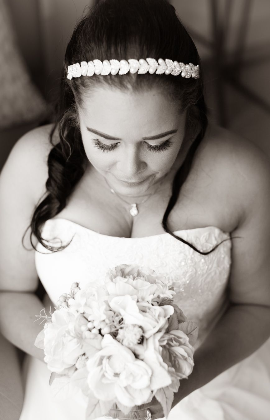 Black and white portraits showing delicate details of a white dress and floral bouquet.