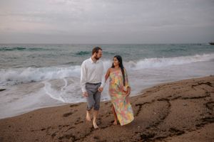 Relaxed couple enjoying a slow walk on Badalona Beach, completely private and away from Barcelona tourist crowds