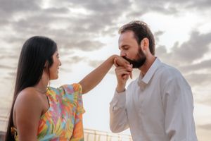 Tender couple kiss on the empty sands of Badalona Beach during a private Mediterranean morning photoshoot