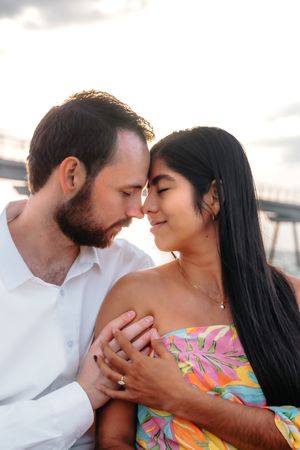 Candid couple walking hand-in-hand along the quiet Badalona Beach promenade during a romantic sunrise session