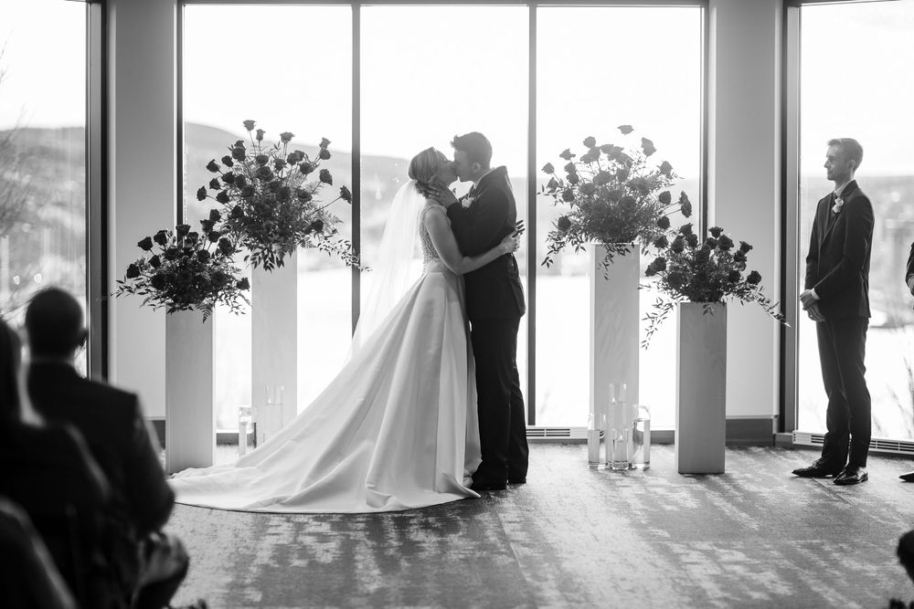 A series of black and white wedding ceremony photos showing couples in formal attire at an elegant indoor venue.