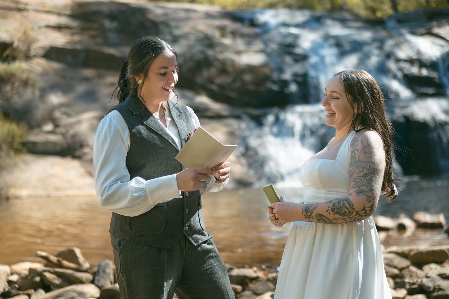 wlw brides reading private vows at Asheville NC waterfall for private elopement ceremony