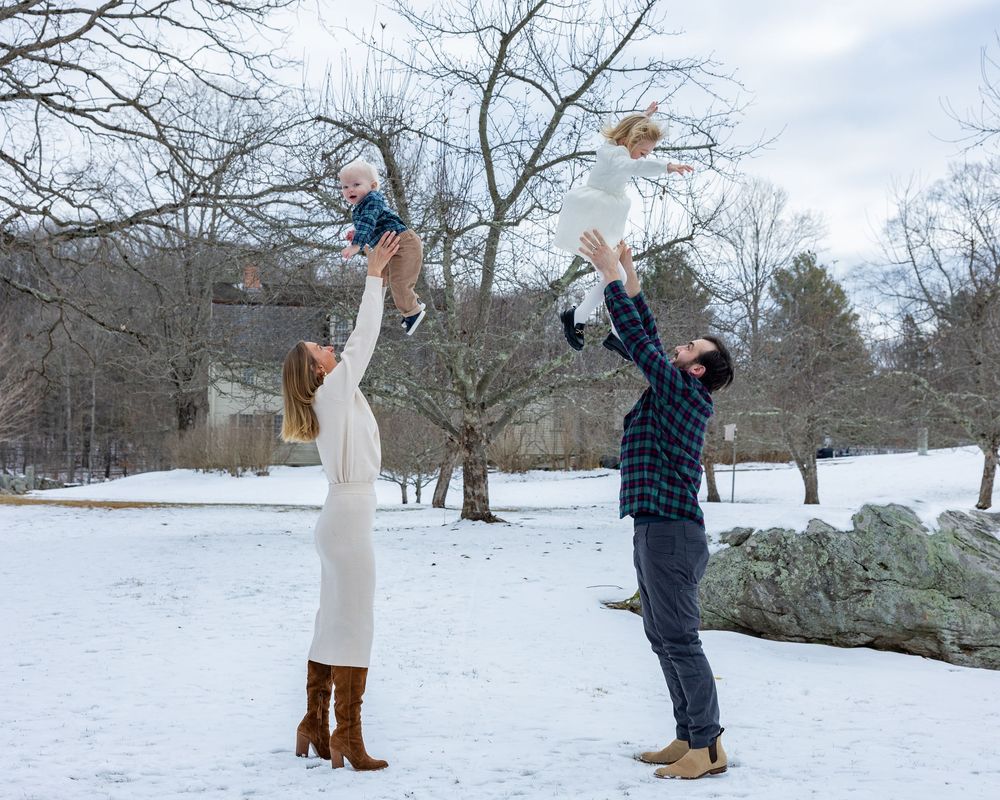 Family plays during a winter family portrait session at Old North Bridge in Concord,MA. Metrowest Boston. Sudbury. Lincoln. Wayland. Weston