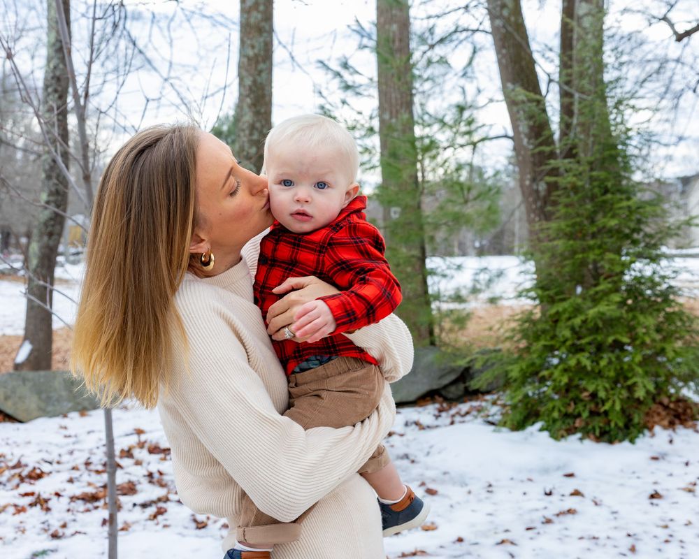 Mom and baby at winter family photo session at Old North Bridge in Concord,MA by Lisa West Photography. Serving Metrowest of Boston.