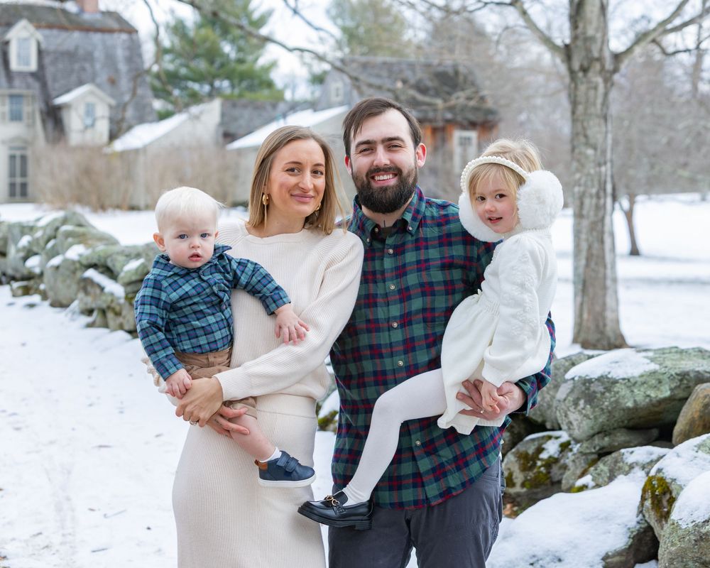 Family at winter family portrait photoshoot at Old North Bridge in Concord,MA by Lisa West Photography. Serving Metrowest and Massachusetts
