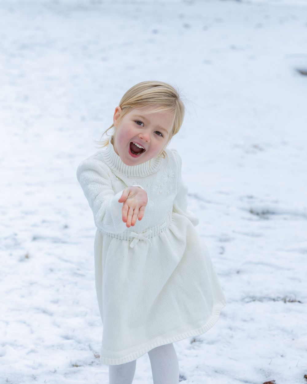 A toddler poses candidly during winter family photos in Concord, MA by Lisa West Photography.  Serving Metrowest of Boston area and Boston.