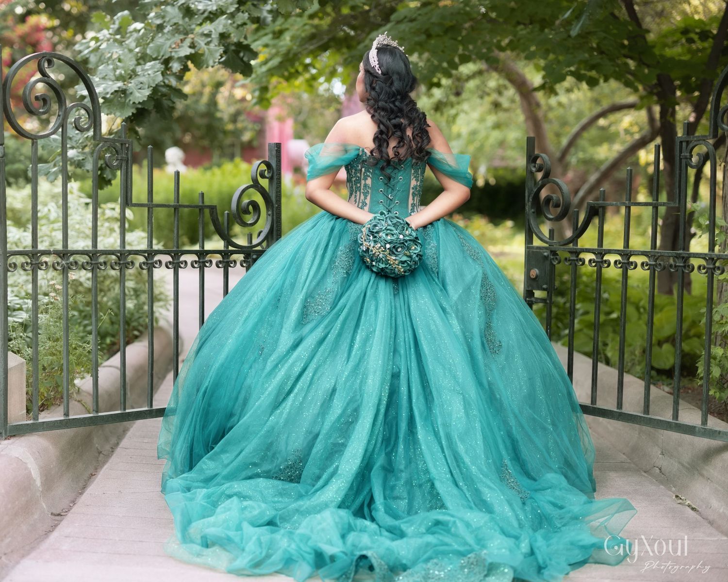A stunning turquoise ball gown with beaded bodice and flowing tulle skirt shown from multiple angles on outdoor steps.