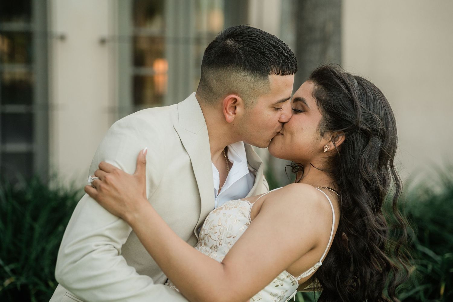 An intimate embrace captured against the backdrop of a classic Mediterranean architecture.