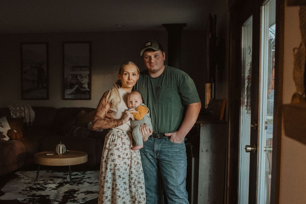 A family shares tender moments together in a sunlit home interior.