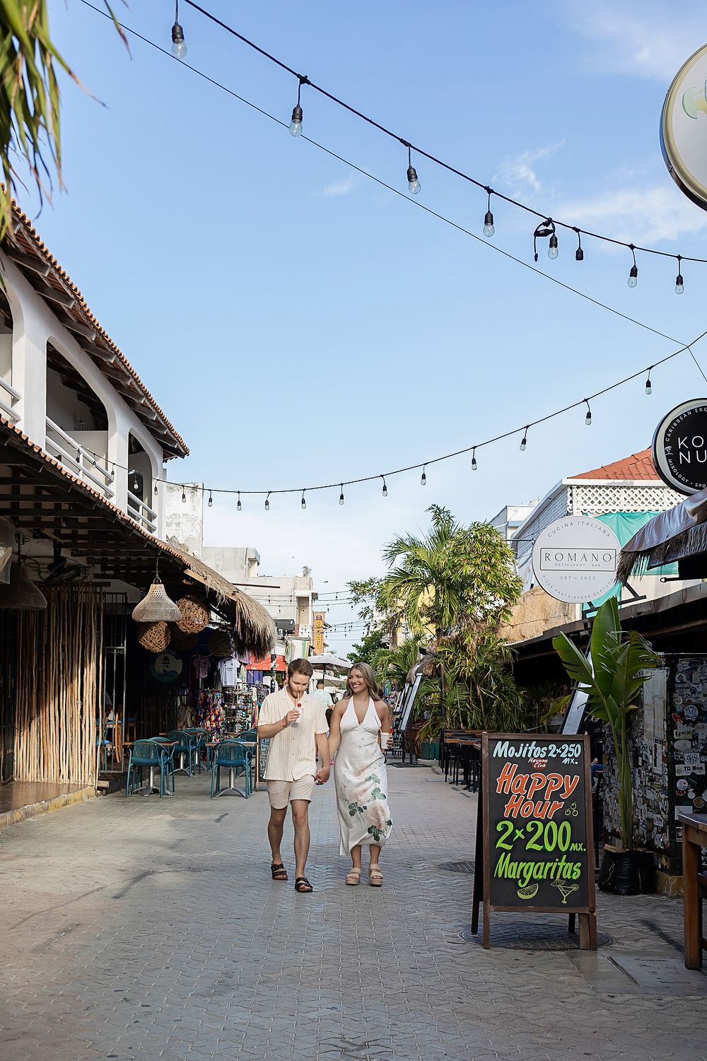 Couple exploring Isla Mujeres streets before sunset beach proposal at Playa Norte.