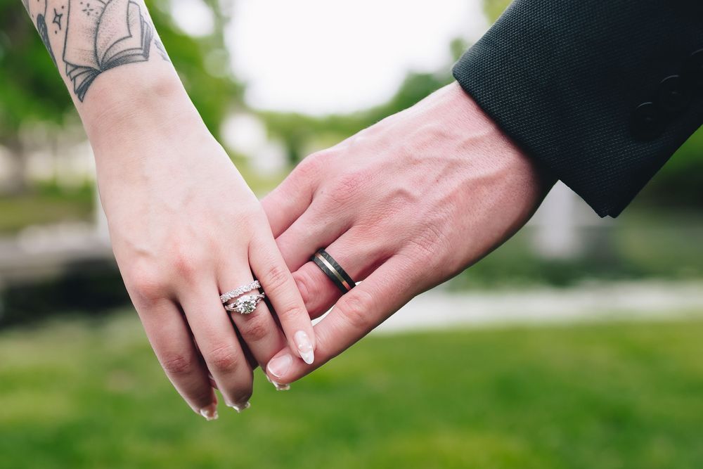 Close-up shots of wedding rings and hands displaying new jewelry.