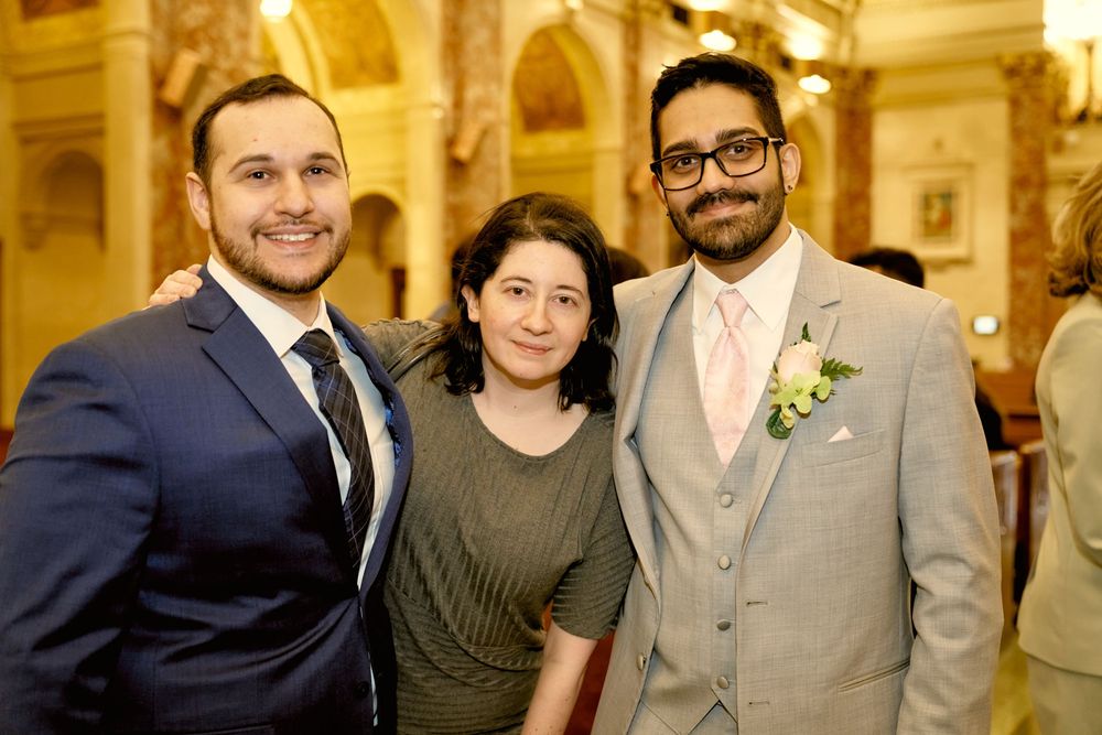 Guests gather in an elegant church hallway with ornate architectural details.