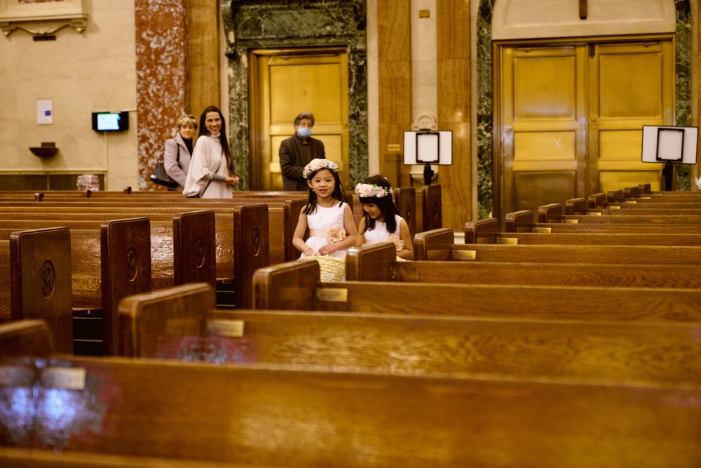 View down rows of empty wooden pews in a historic church sanctuary.