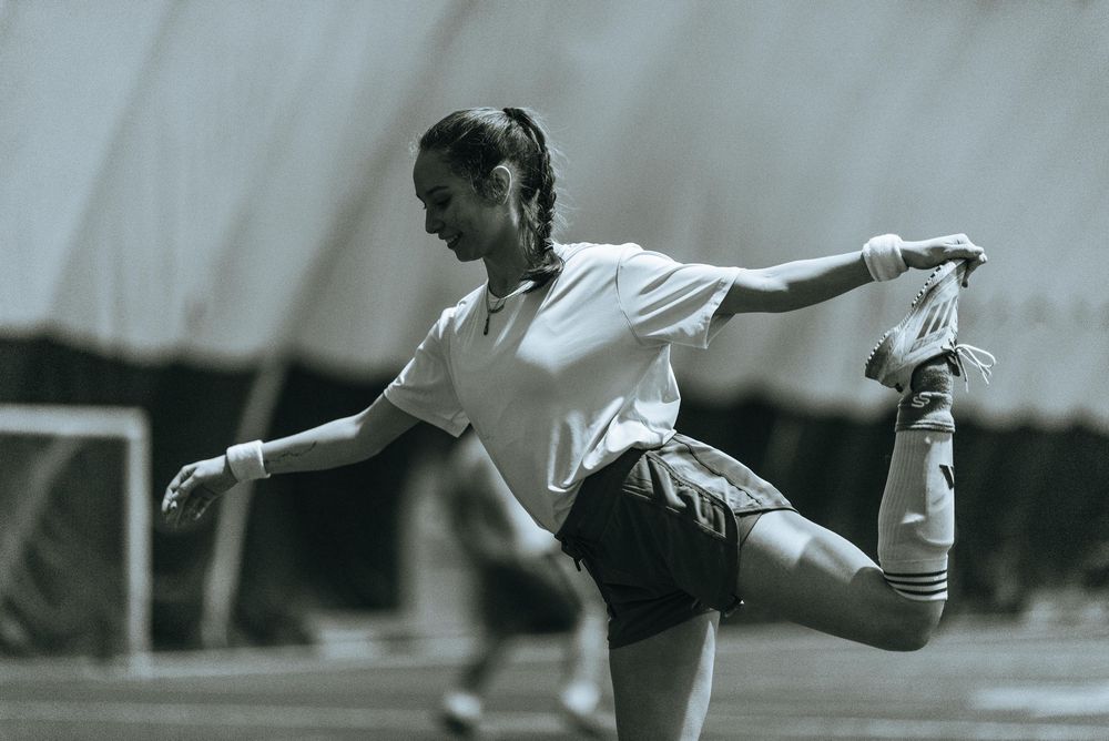 Soccer Player stretching and balancing.