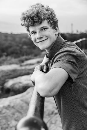 Black and white portrait series shows someone looking away from camera with a small smile in each frame.