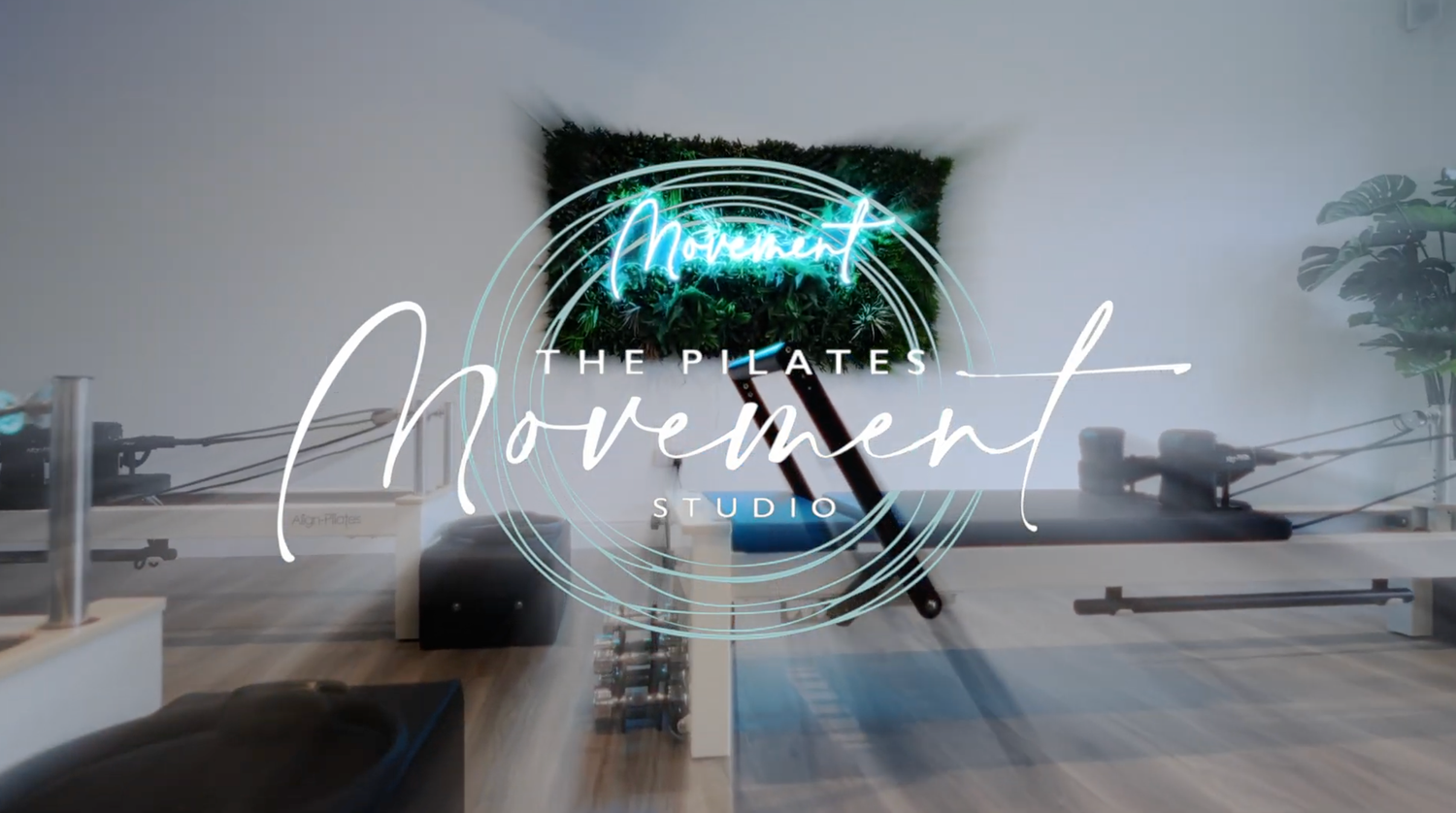 Modern event space with neon sign and minimalist decor.
